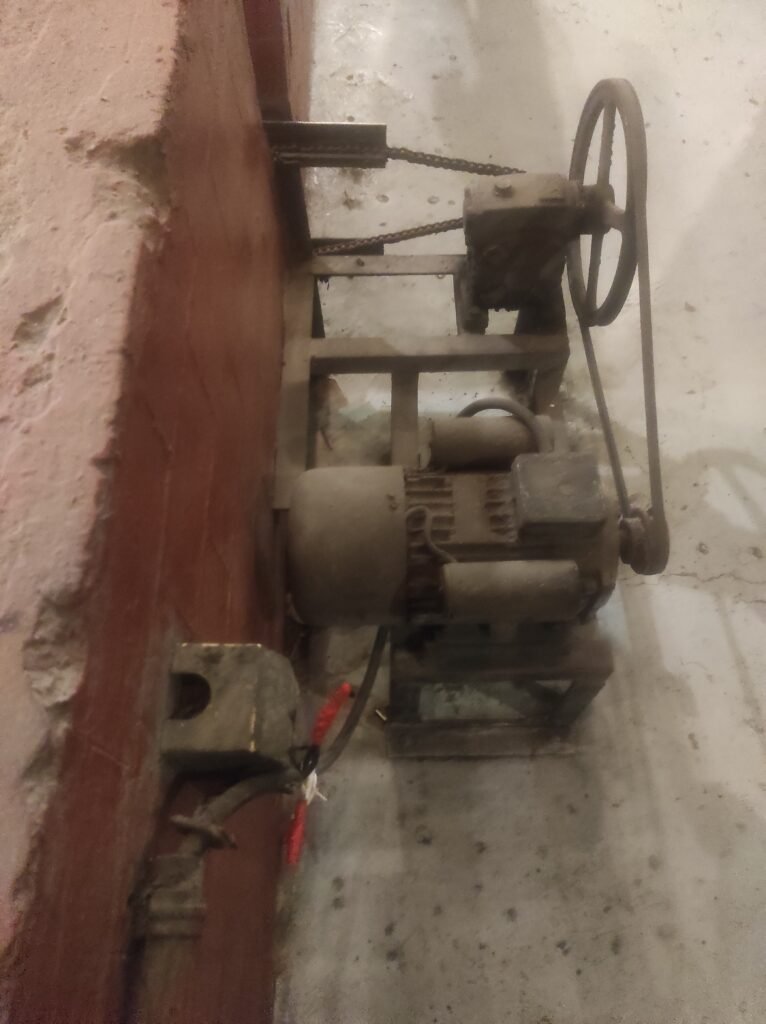 Industrial electric motor and drive mechanism illustrating rotating machinery monitored with vibration sensing