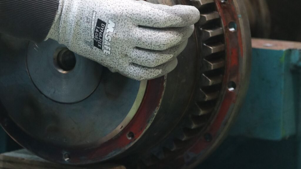 Technician adjusting industrial gearing for PyXis machine profile configuration