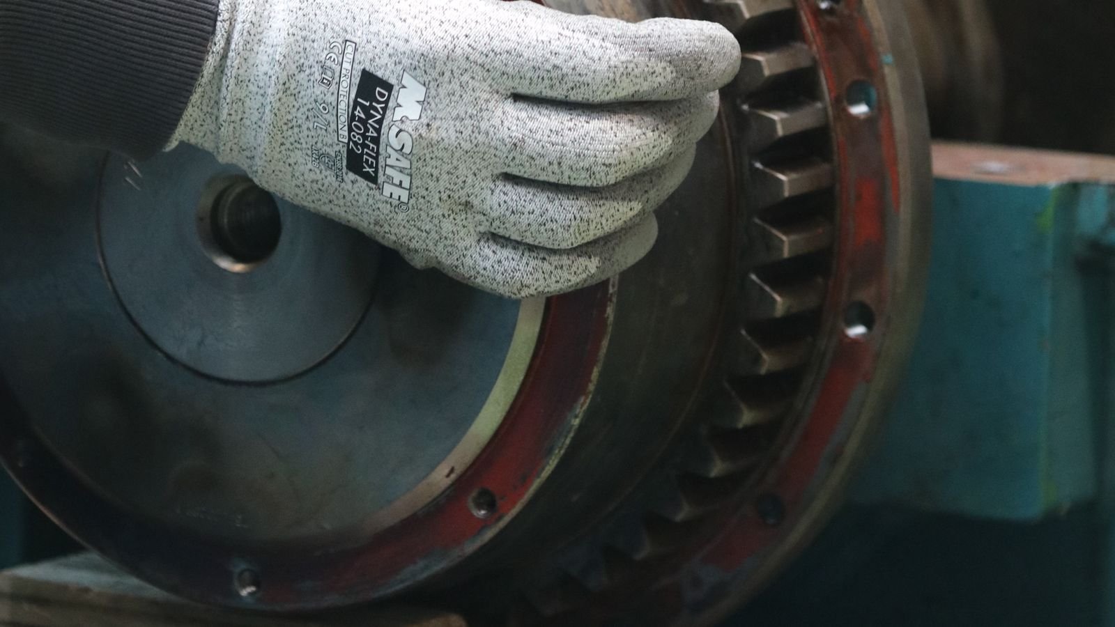Technician adjusting industrial gearing for PyXis machine profile configuration