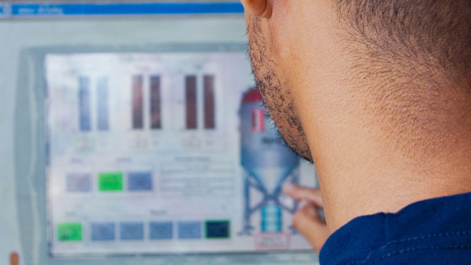 Engineer reviewing industrial control-panel configuration during a controlled commissioning procedure