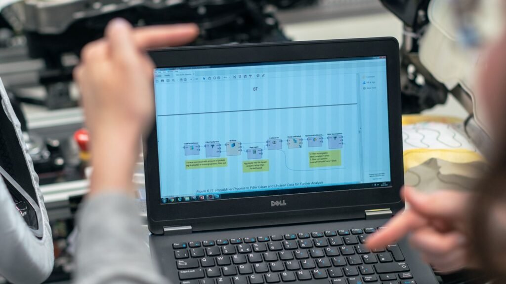 Engineers analysing frequency and amplitude data on a laptop for PyXis harmonic array integration