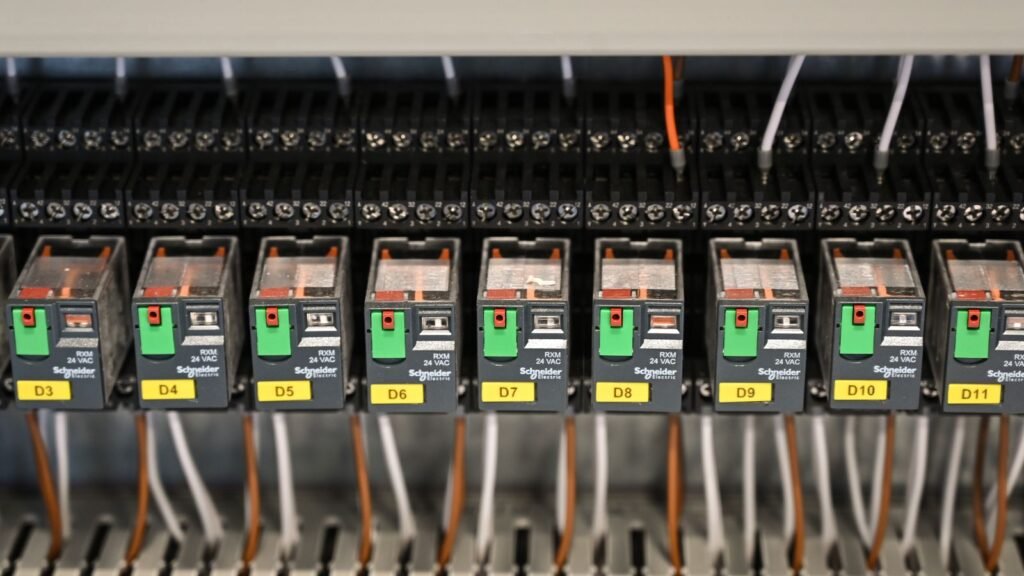 Industrial relay panel illustrating Titania Boolean logic commissioning and pattern testing